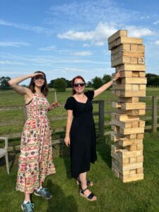 Imag shows a tower of Jenga with Two of the Modo25 team 