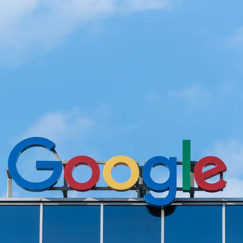 Image shows Google's logo onto of a building.