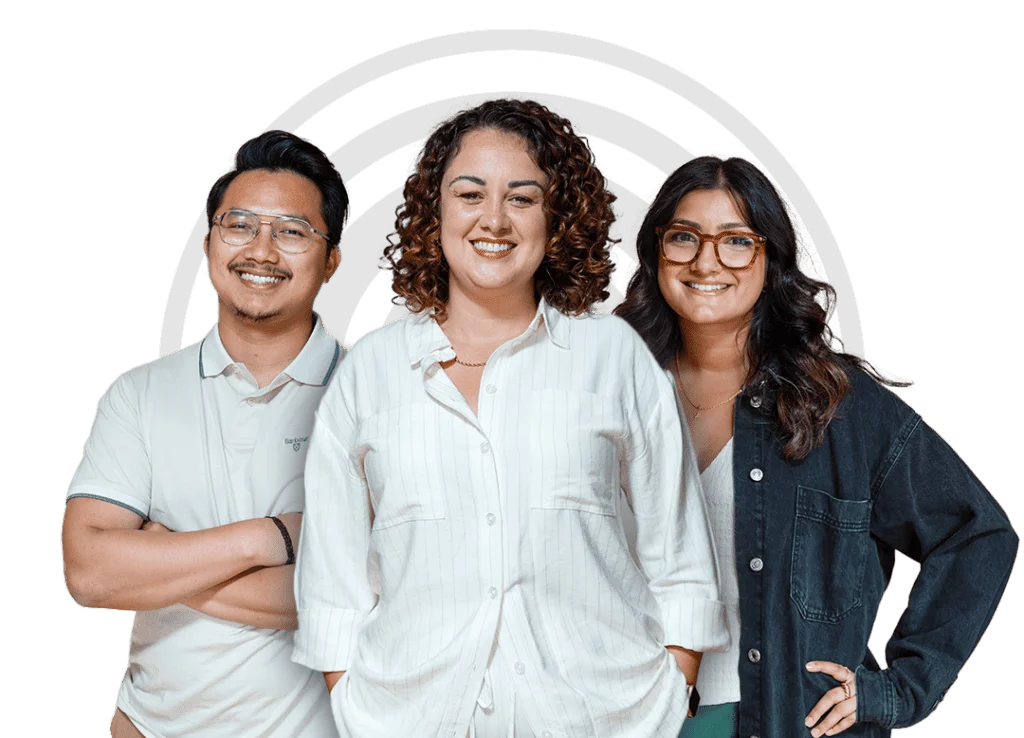 Three smiling professionals stand together against a white background with a subtle arc design.