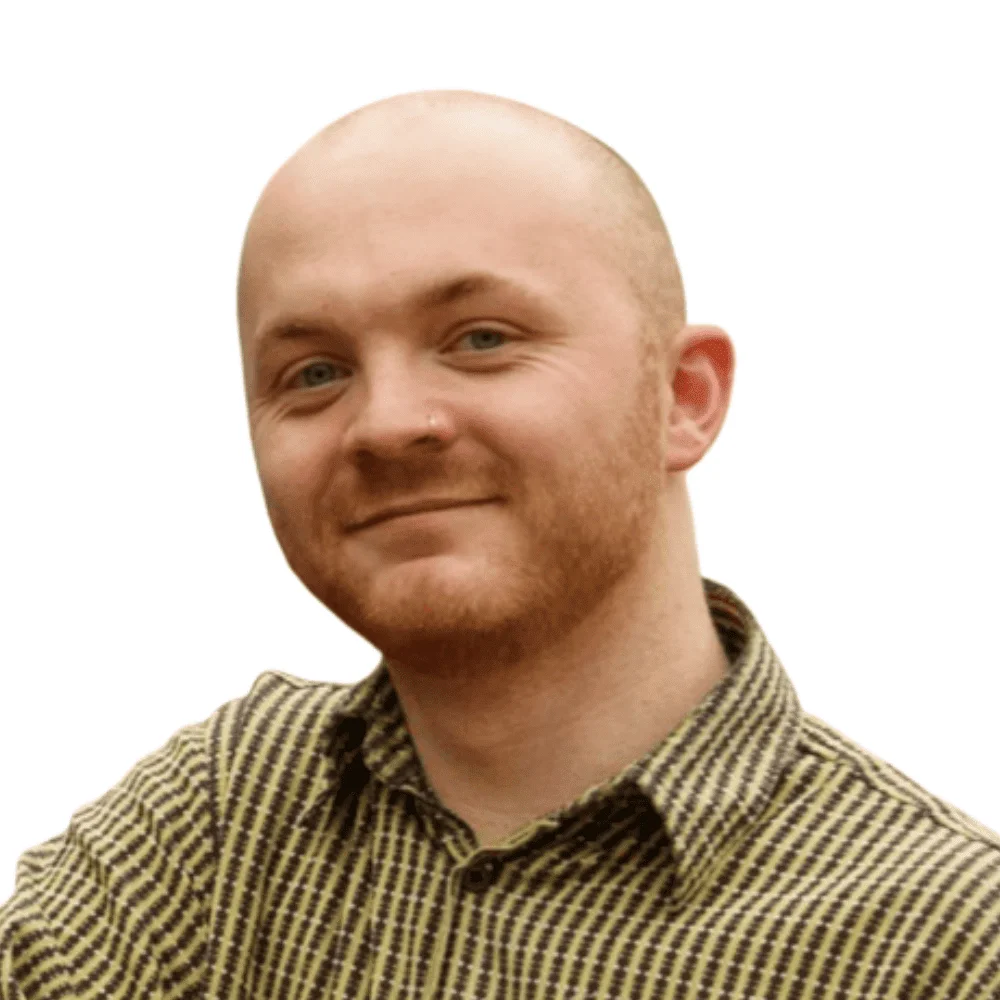 Headshot of a bald man with a ginger beard, smiling, representing the Paid Social team.