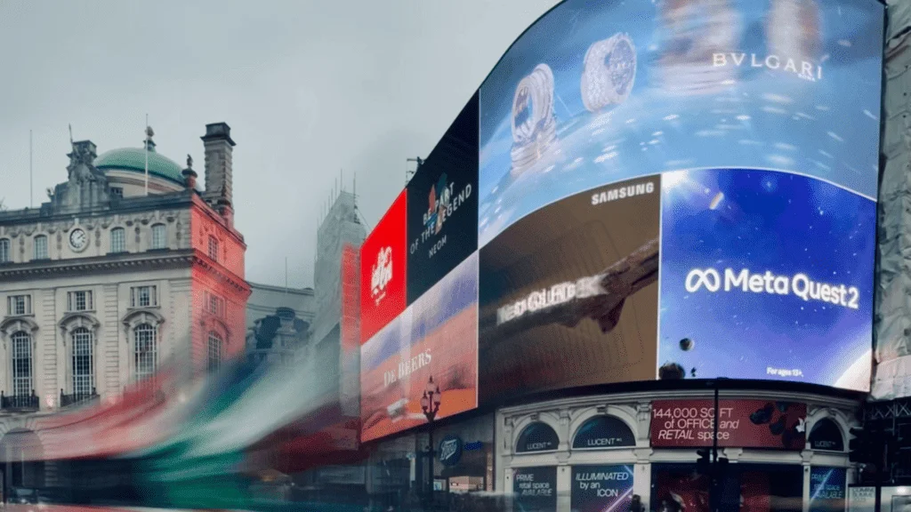 Digital Out of Home advertising screens at Piccadilly Circus displaying ads for Bulgari, Samsung, and Meta Quest 2.