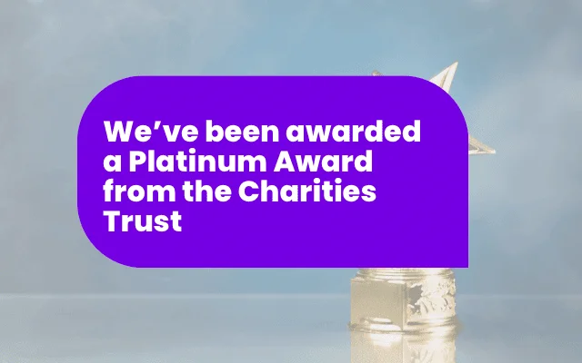 Announcement banner celebrating a Platinum Award for performance from the Charities Trust, with a trophy in the background.