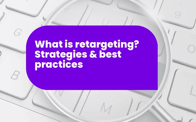 Magnifying glass over keyboard highlights retargeting strategies for improved marketing performance