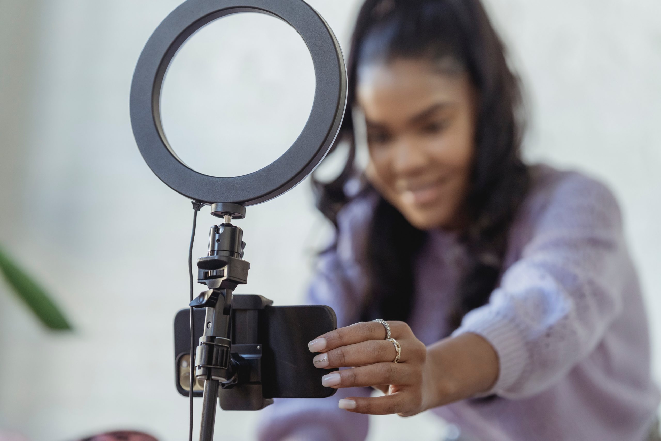 Young woman setting up a phone and a ring light, influencer marketing
